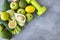 lemon, avocado, zucchini, cucumber, celery, dumbbell, apples, grey, background, green vegetables on grey background