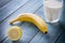 Lemon, Banana and Milk in Glass on a Vintage Wooden Background