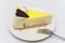 Lemon cheese cake with chocolate heart on a white plate
