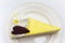 Lemon cheese cake with chocolate heart on a white plate