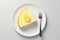 Lemon cheesecake with piece of fresh lemon on top on a plate over minimalist white background with a fork