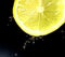 Lemon. Citrus. A slice of lemon on a dark background. Lemon juice.