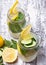 Lemon and cucumber detox water in glass jars