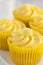 Lemon cupcakes with butter cream swirl and candid fruit decoration