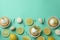 Lemon cupcakes, macaroons and ingredients on mint