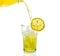 Lemon drink pouring into glass on white