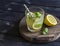 Lemon, ginger and mint lemonade on a wooden rustic board.