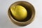 Lemon and insulated wooden bowl on a white background