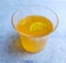 Lemon juice in glass with added syrup orange and slice of lemon inside and outside of glass placed beautifully in white background