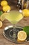 Lemon Martini cocktail and fresh fruits on wooden table