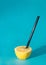 Lemon minimal with black straw. Juicy fruit minimal concept. Summer sunny day on a sky blue background