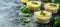 Lemon mousse in glass bowls with basil garnish on a marble counter, a refreshing dessert