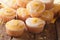 lemon muffins with icing sprinkled with zest close-up. horizontal