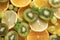 Lemon, orange ,  mint, sprig , green grapes, kiwi, on a grey ,fresh citrus and fruit, top view