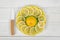 Lemon peaces laid out around the whole lemon on a saucer