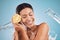 Lemon, skincare and black woman with a beauty water splash, product marketing and nutrition against a blue background in