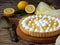 Lemon tart pie with meringue cream. Homemade cake on wooden background. Horizontal photo