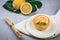 Lemon tart on a white plate decorated with lemons. Enjoy fresh baked dessert in restaurant