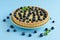 Lemon tartlet decorated with blueberries and mint