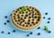 Lemon tartlet decorated with blueberries and mint