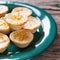 Lemon Tartlets on a green plate, wooden background