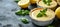 Lemon tartlets Posset with basil leaves, a perfect combination of citrus and herb, on a dark slate