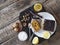 Lemon tea and homemade holiday pumpkin chocolate soft cake, drenched with chocolate on a dark kitchen board with walnuts on a