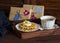 Lemon tea, waffles with ice cream, honey and nuts in a vintage tray, homemade Valentine\'s day gifts in kraft paper