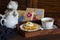 Lemon tea, waffles with ice cream, honey and nuts in a vintage tray, homemade Valentine\'s day gifts in kraft paper