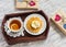 Lemon tea, waffles with ice cream, honey and nuts in a vintage tray, homemade Valentine\'s day gifts in kraft paper