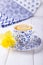 Lemon tea and yellow daffodil on a white background. Free space
