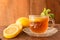 Lemon Teacup with lemon slices and mint leaf on a wooden background