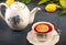 Lemon teapot and tea cup with blue background