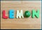 Lemon wooden word on chopping block