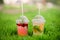 Lemonade with berries grape kiwi orange basil lime on green grass summer spring cafe restaurant daylight street light bokeh