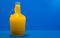 Lemonade in glass bottle on blue background