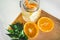 Lemonade in a glass bowl with a straw. view from above. oranges cut on the table. healthy natural vitamin drinks. organic food