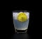 Lemonade with ice in crystal glass on black background