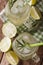 Lemonade lime with ice and rosemary macro in a glass jar. vertical top view