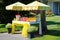 lemonade stand during the summer, with cheerful sunshades and ice-cold cups of fresh lemonade