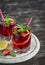 Lemonade with strawberries, lemon and mint in glass beakers