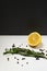 Lemons with cloves and fresh rosemary on white and black background. Place for text.