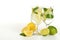 Lemons and limes in a glass with water on white background