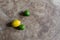 Lemons and limes  on a stone tile background