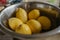 Lemons in the stainless steel soup bowl in the kitchen