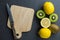 The lemons are on top of wood cutting board with knife. Top view with copy space, flat lay