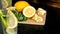 Lemons on a wooden board and two glasses with homemade lemonade