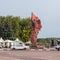 Lenin statue on Lenin square with flags in national colors and soviet retro car in Mozyr, Southern Belarus