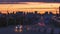 Lens blur. Cars drive against the background of the silhouette. Panoramic view of a beautiful sunset in a European city