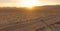 LENS FLARE: Flying above a SUV cruising across the Mojave desert at sunset.